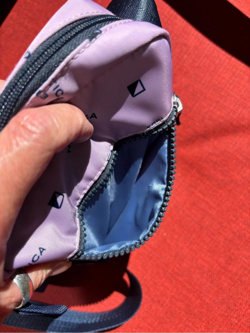 Nautica Pink Logo Print Crossbody Bag with Navy Strap and trim.